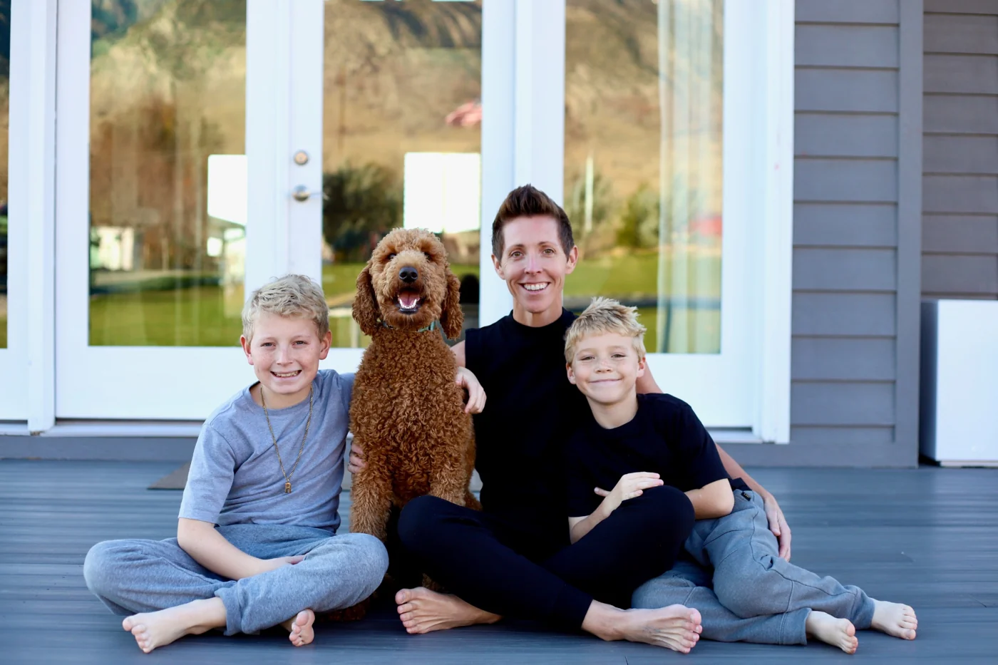 Kenzie enjoying time outdoors with her two sons and their dog